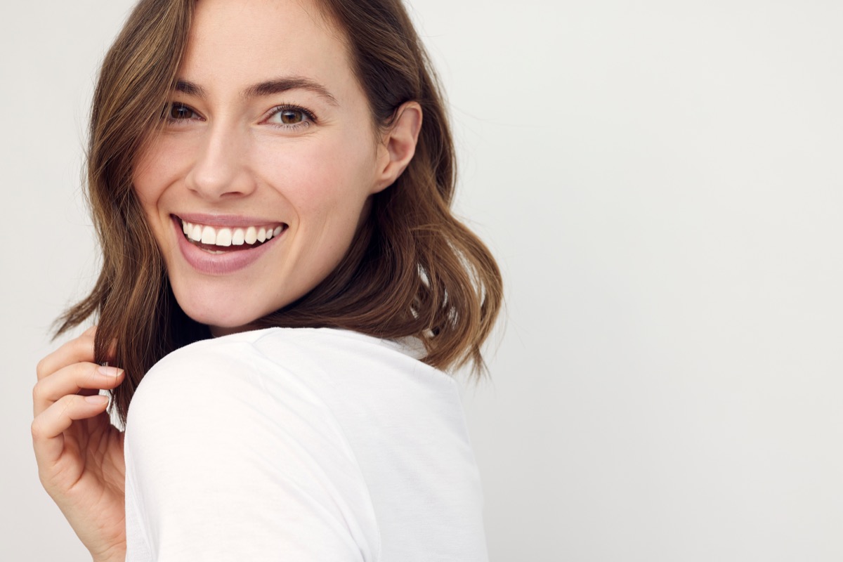 Smiling patient against a light backdrop